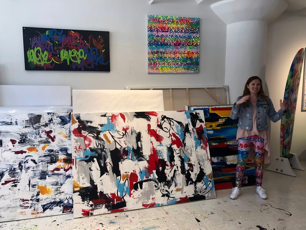 The artist, clad in custom leggings sporting her I Love You graffiti, walked us through her evolution from abstract expressionism to text-based art.